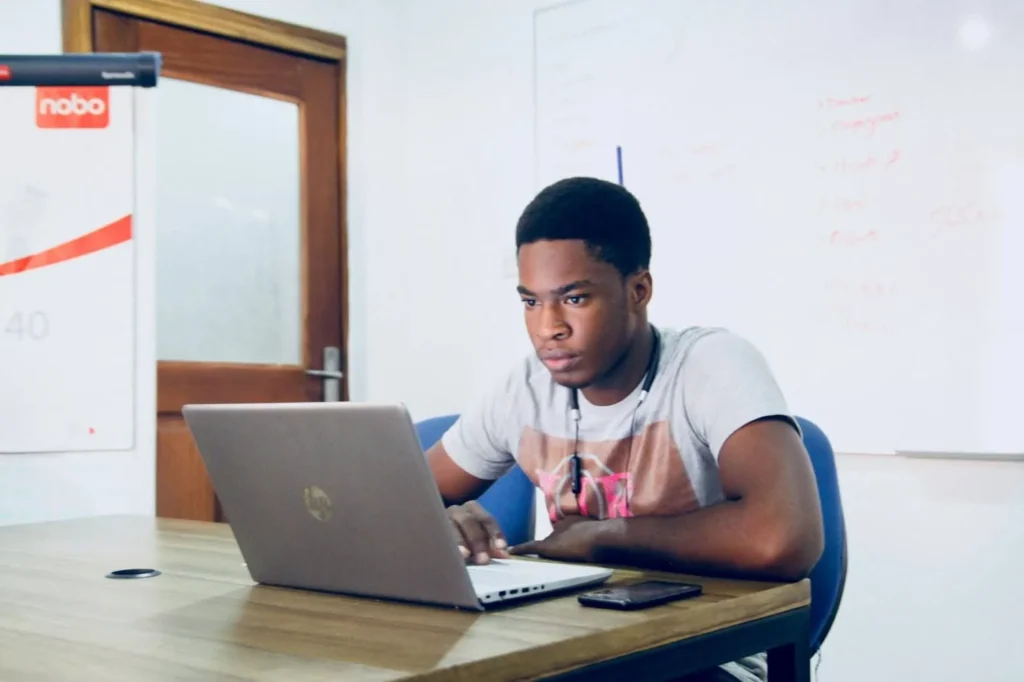 Student with his laptop, preparing for the inburgering exam in the Netherlands.